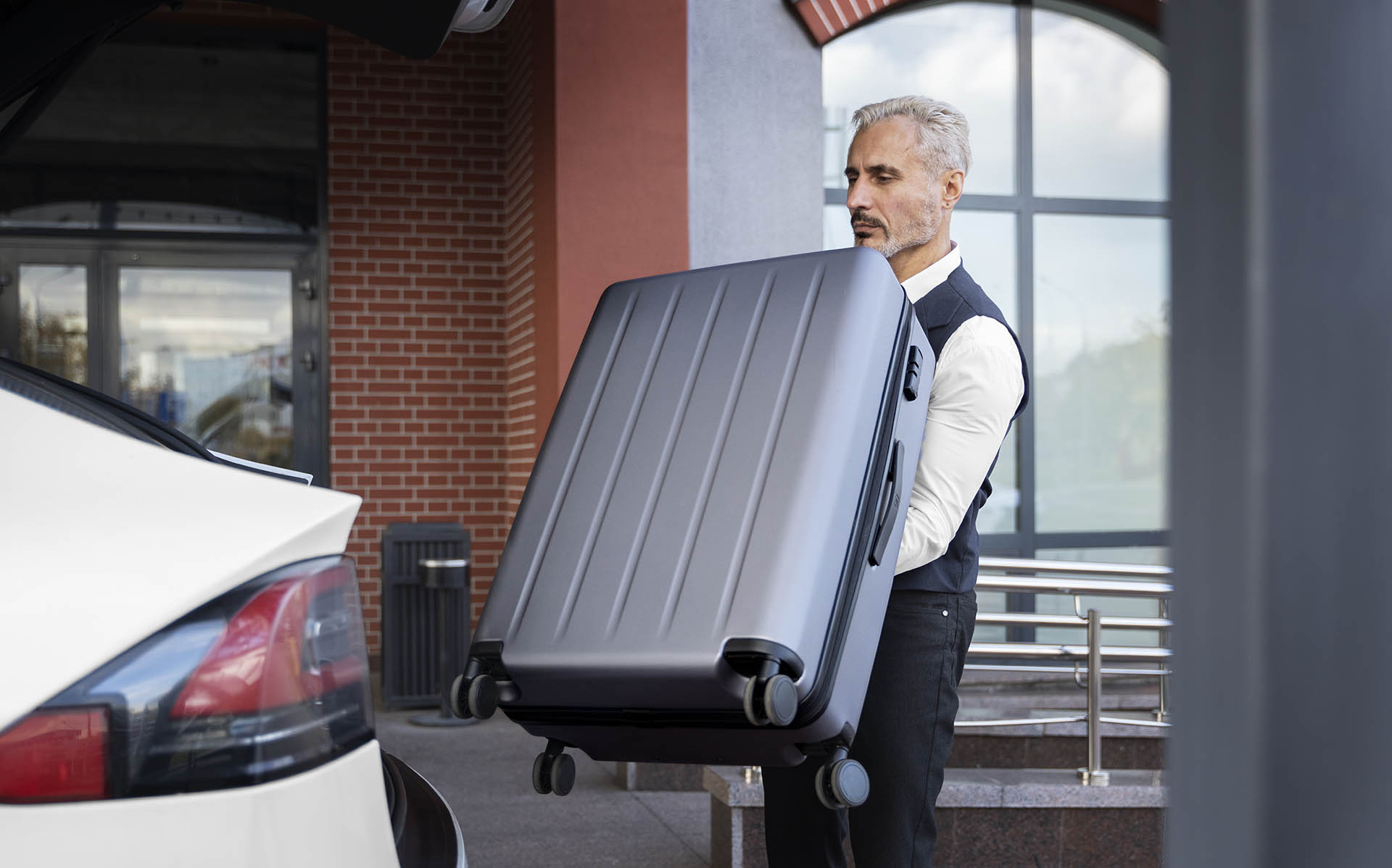 valet-holding-baggage-side-view